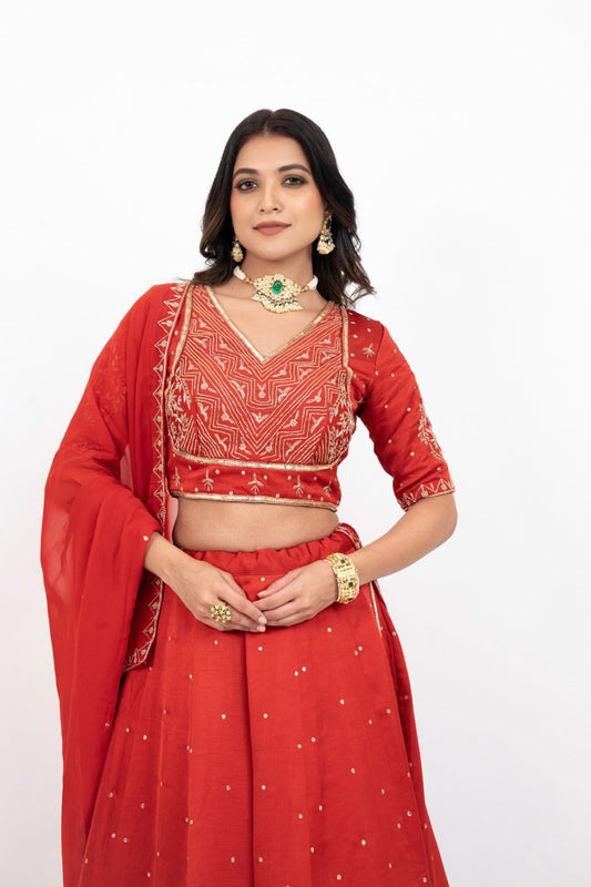 Rust soft silk zardozi embroidered lehenga choli with hand cut dana work