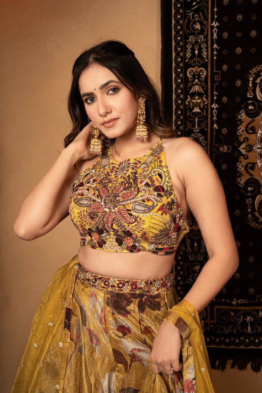 Yellow tissue silk lehenga choli with knot and cut dana work