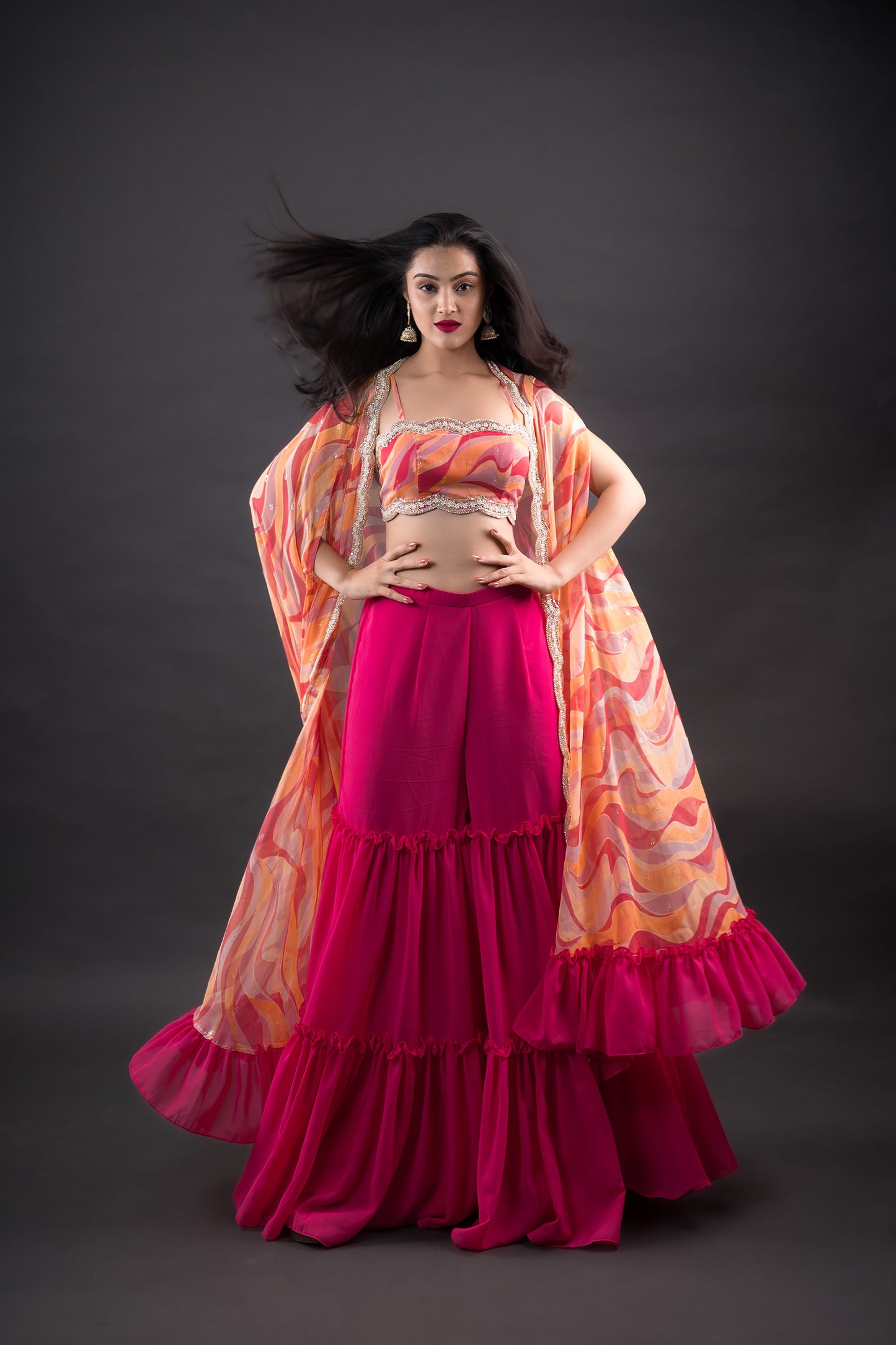 Hot pink Gharara Pants paired with abstract printed crop-top and long cape
