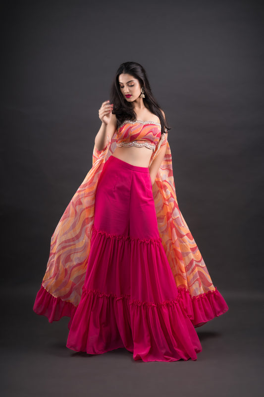 Hot pink Gharara Pants paired with abstract printed crop-top and long cape