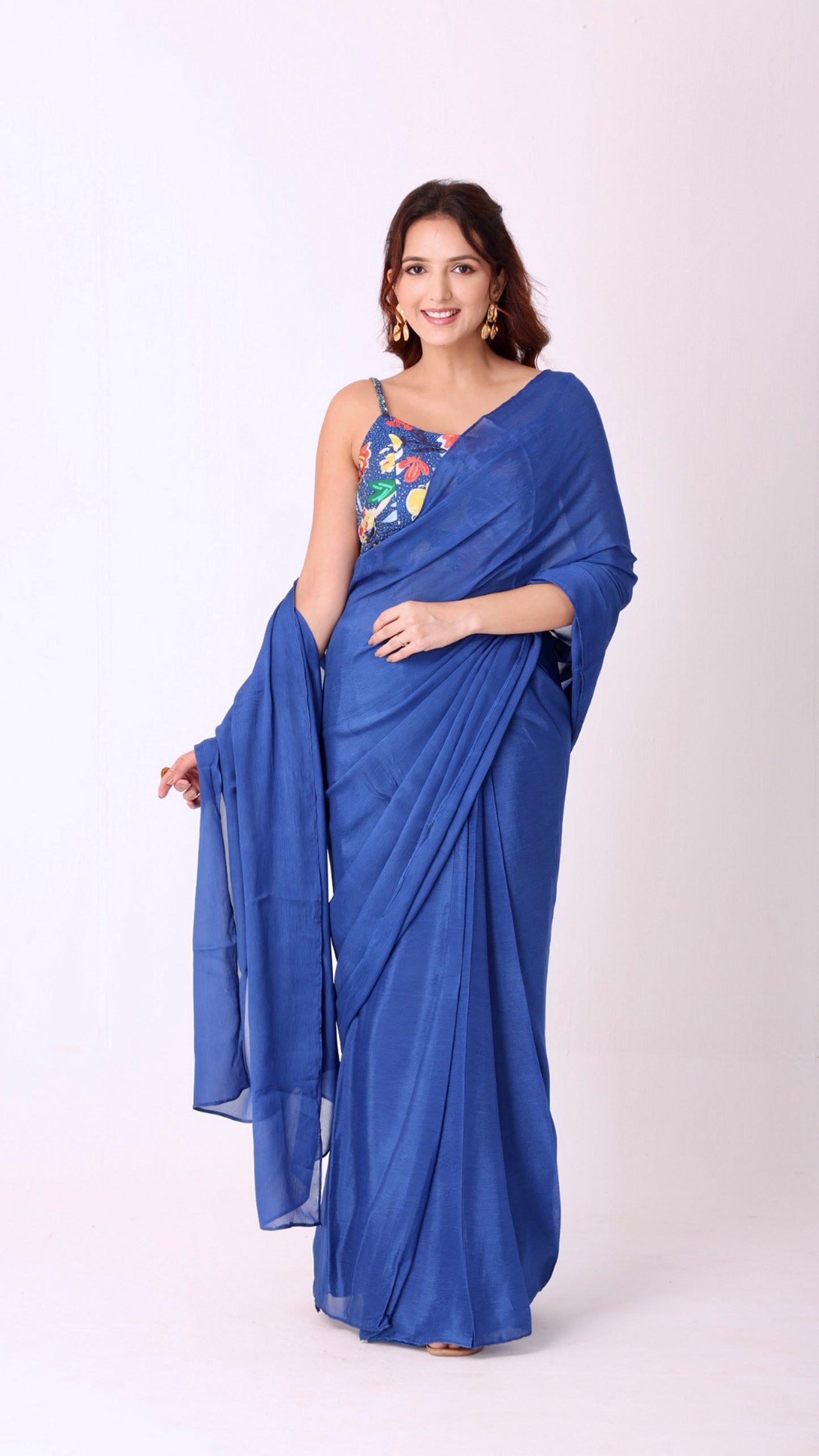 Elegant solid blue saree paired with a vibrant floral blouse