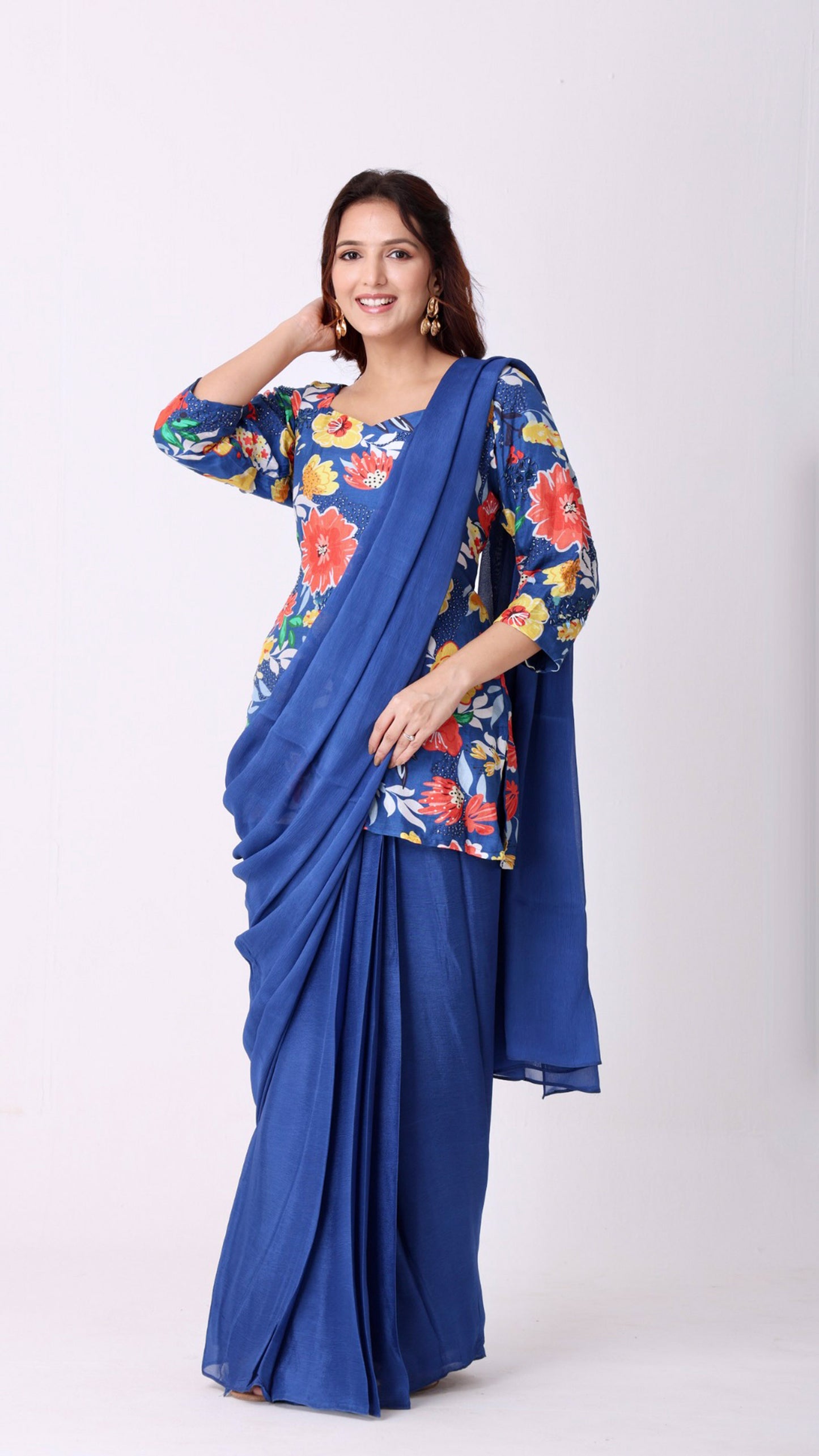 Solid deja vu blue saree paired with a hand-embroidered floral kurti blouse
