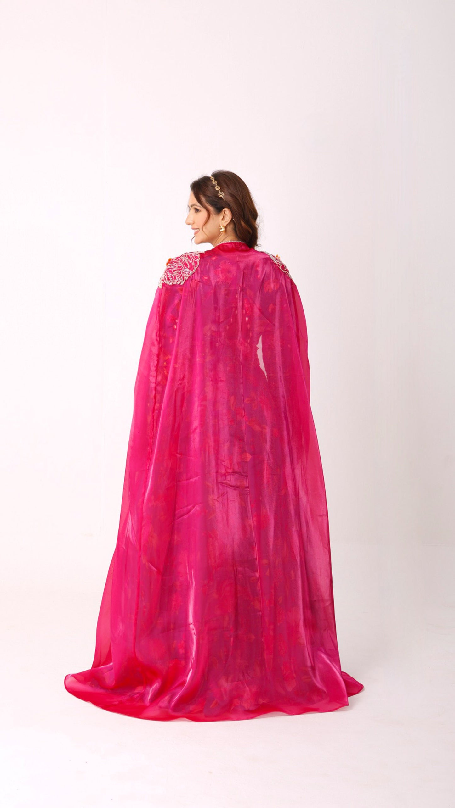 Turquoise vibrant floral lehenga choli set paired with a embroidered cape