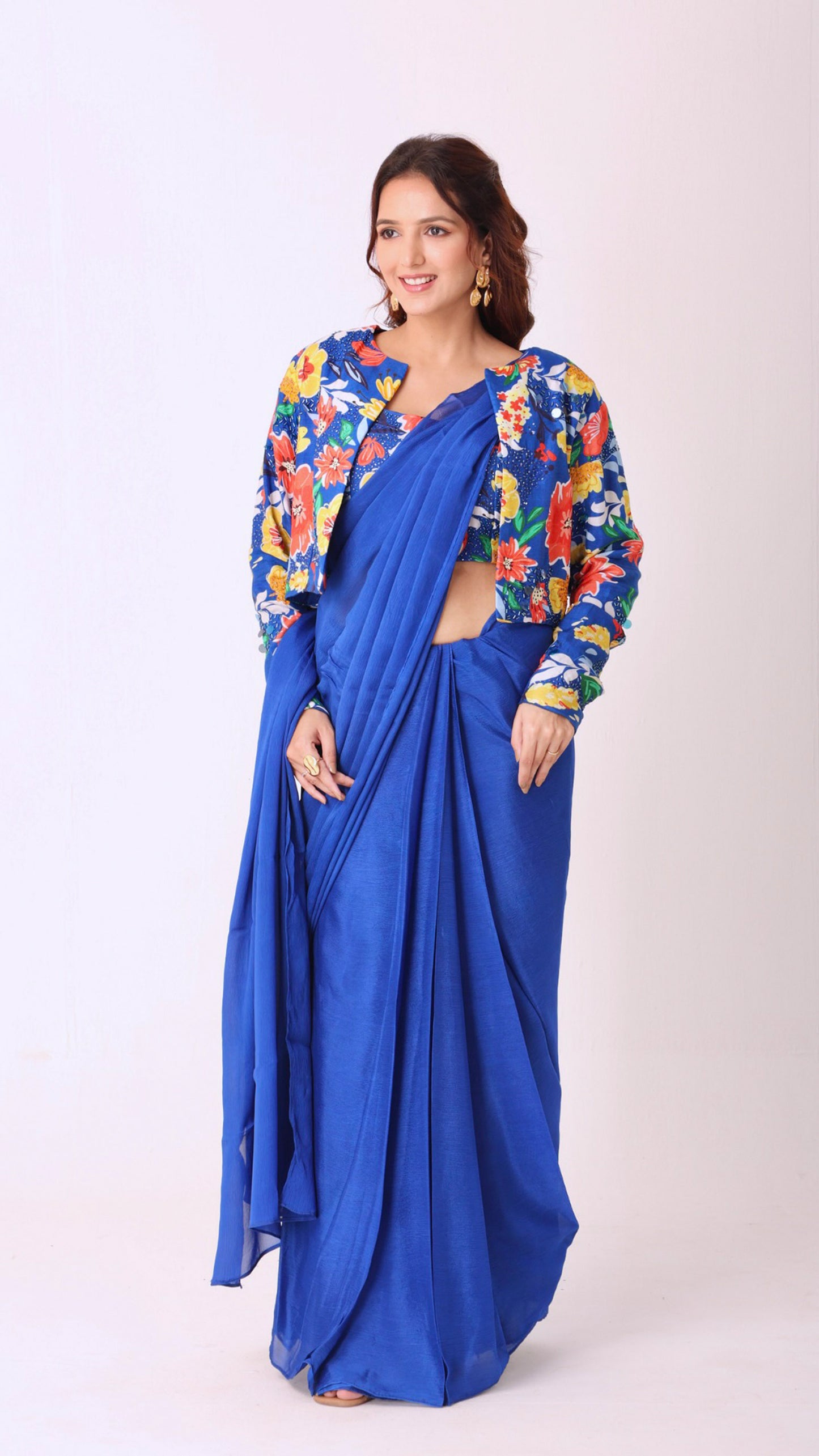 Hand-embroidered blouse and jacket paired with a solid blue saree