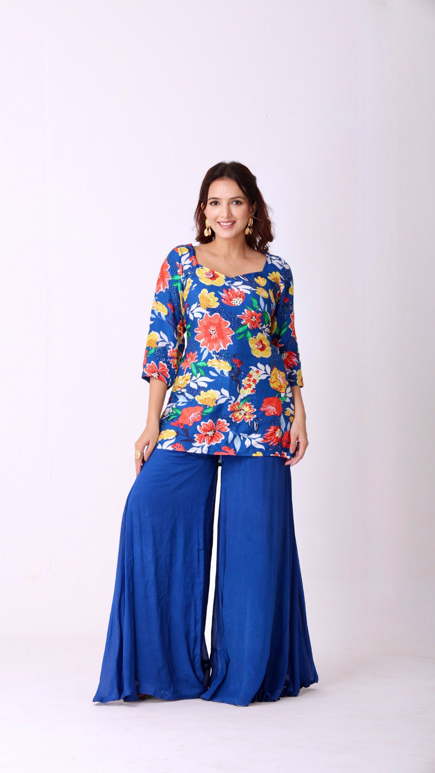 Floral hand-embroidered kurta paired with flowy flare blue sharara pants