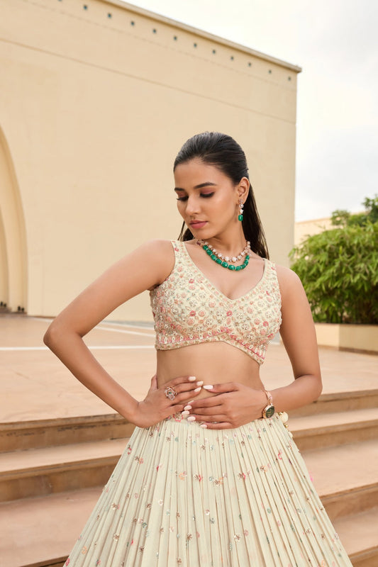 Off-white silk lehenga choli with sequins and hand cut dana work
