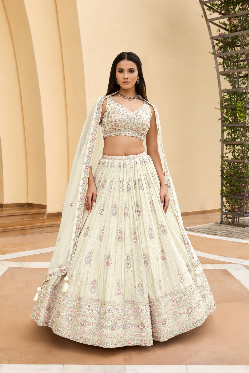 Off-white georgette lehenga choli with hand cut dana and sequins work