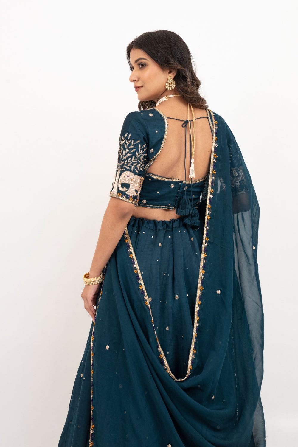 Peacock blue soft silk zardozi embroidered lehenga choli with hand cut dana work