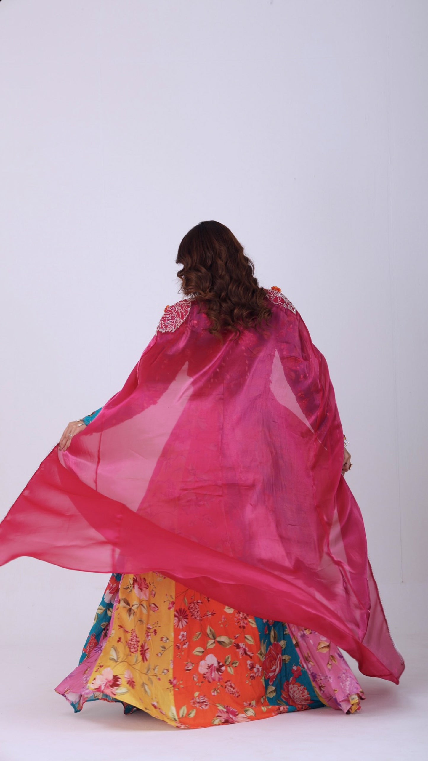 Orangeade Bold multi-colour floral kali lehenga paired with embroidered blouse and cape