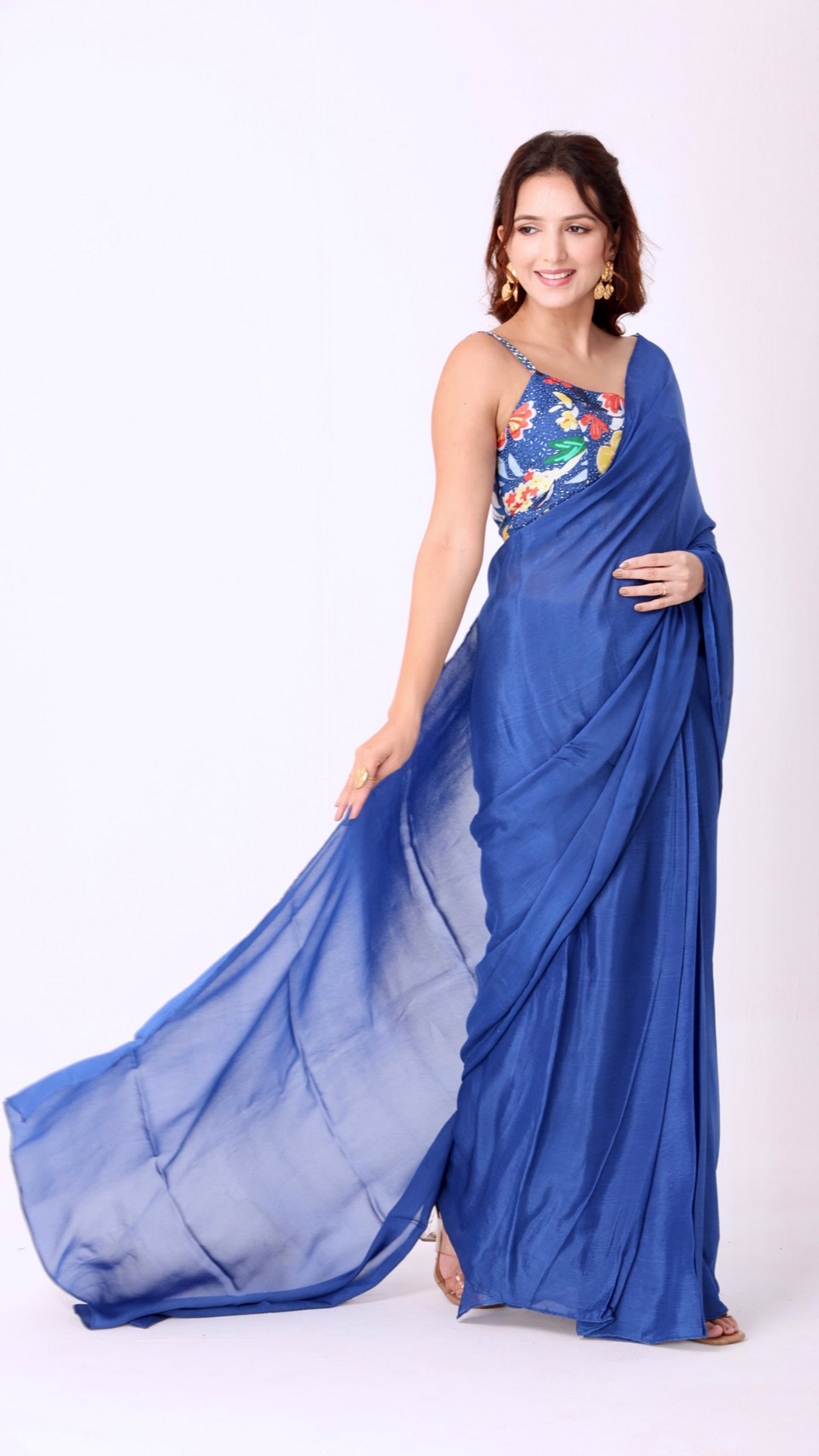 Elegant solid blue saree paired with a vibrant floral blouse