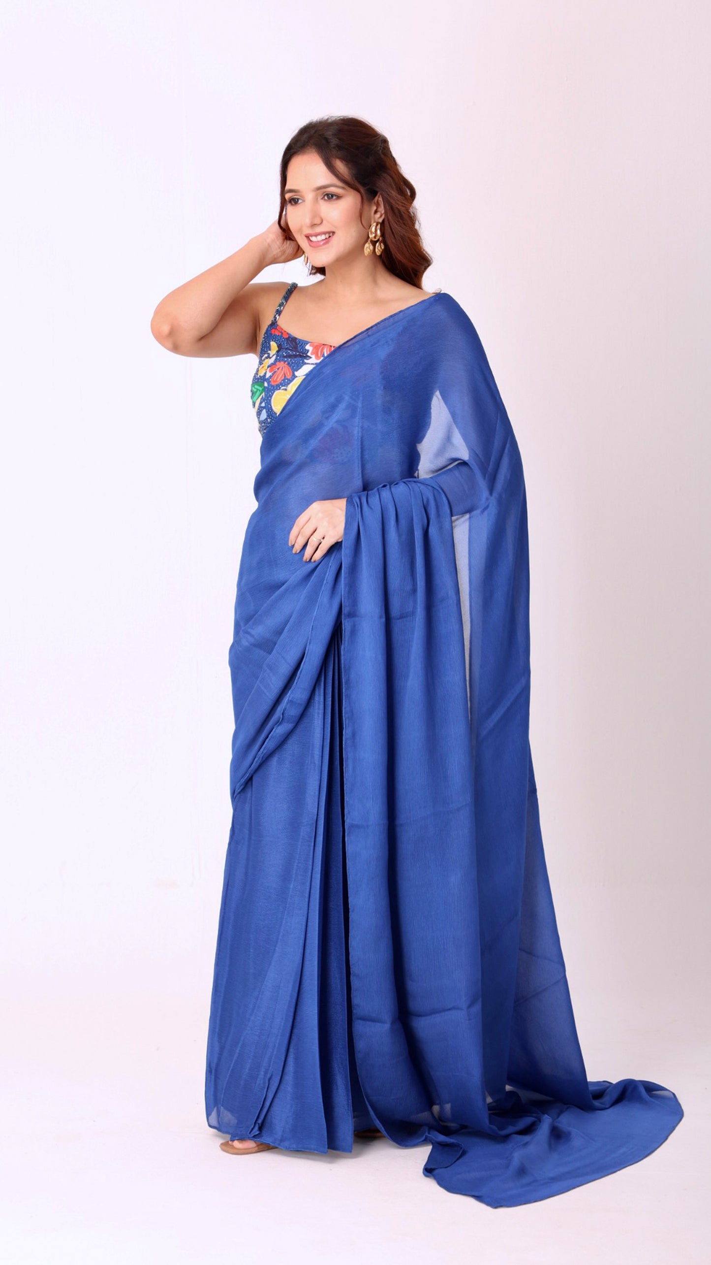 Elegant solid blue saree paired with a vibrant floral blouse