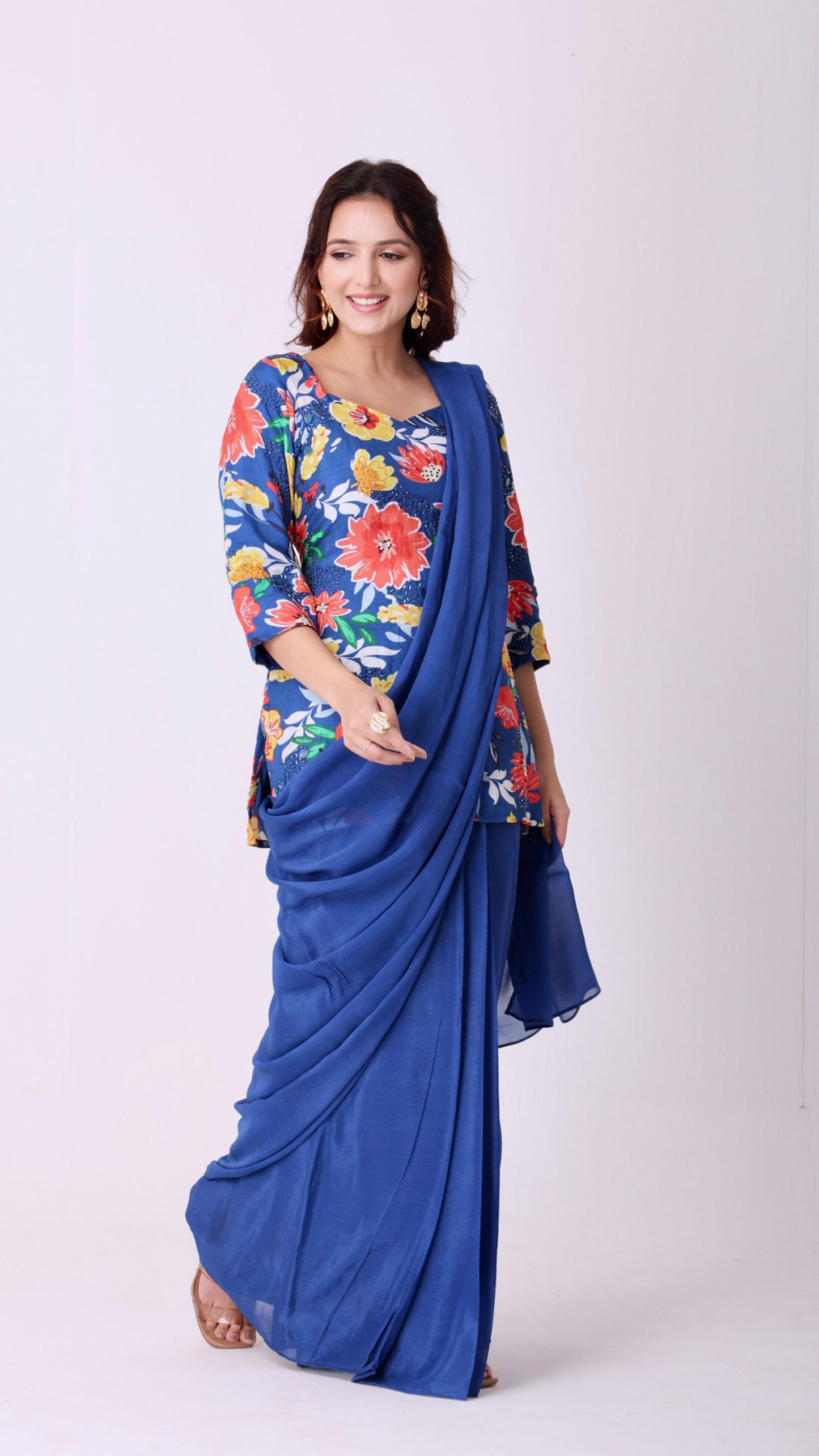 Solid deja vu blue saree paired with a hand-embroidered floral kurti blouse