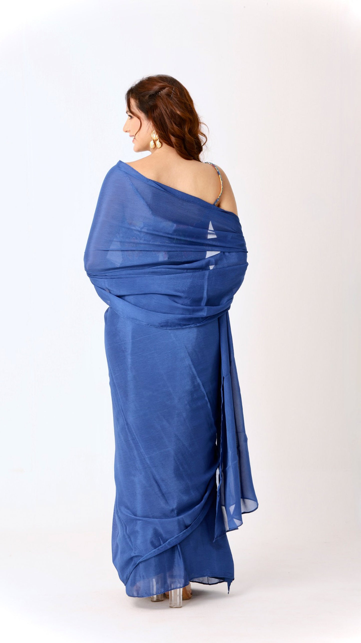 Elegant solid blue saree paired with a vibrant floral blouse