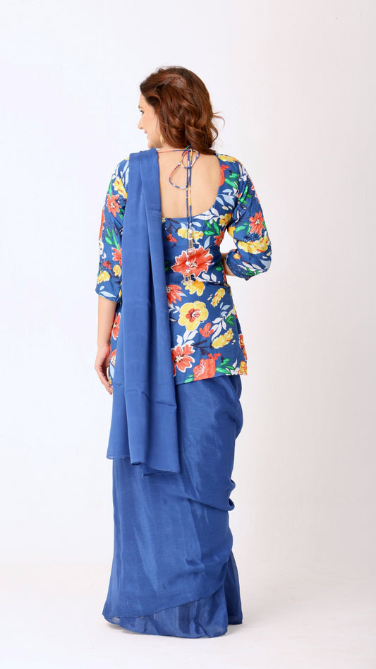 Solid deja vu blue saree paired with a hand-embroidered floral kurti blouse