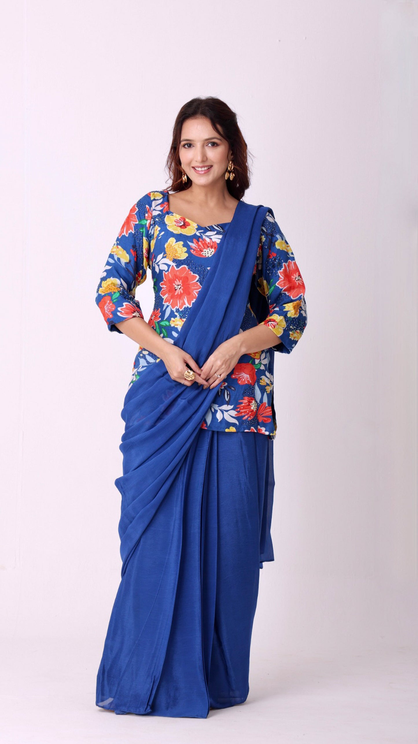 Solid deja vu blue saree paired with a hand-embroidered floral kurti blouse