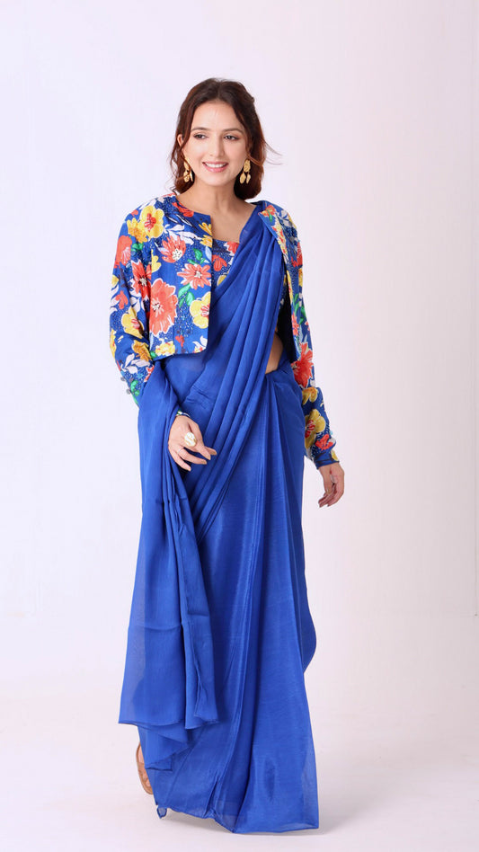 Hand-embroidered blouse and jacket paired with a solid blue saree