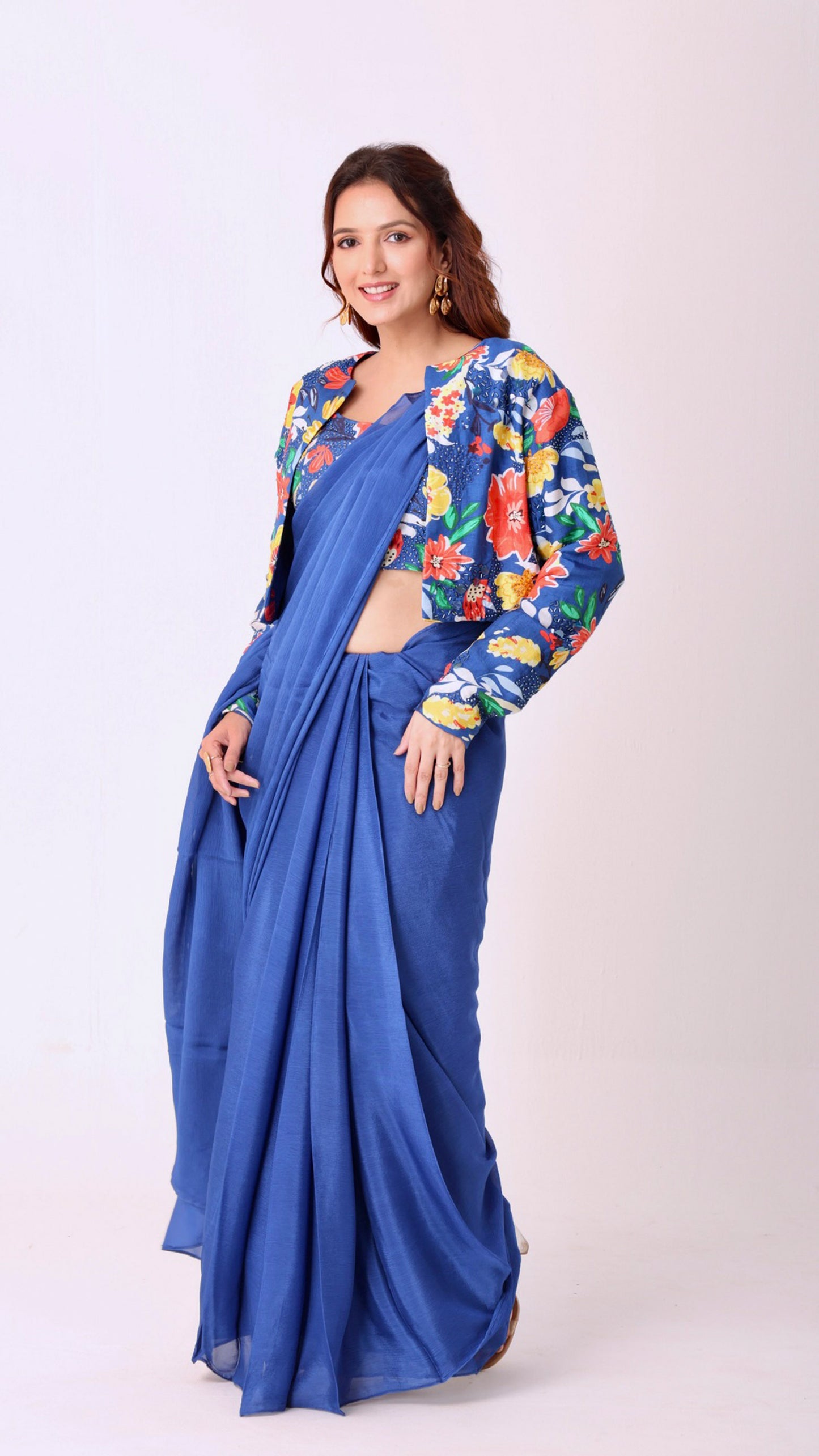 Hand-embroidered blouse and jacket paired with a solid blue saree