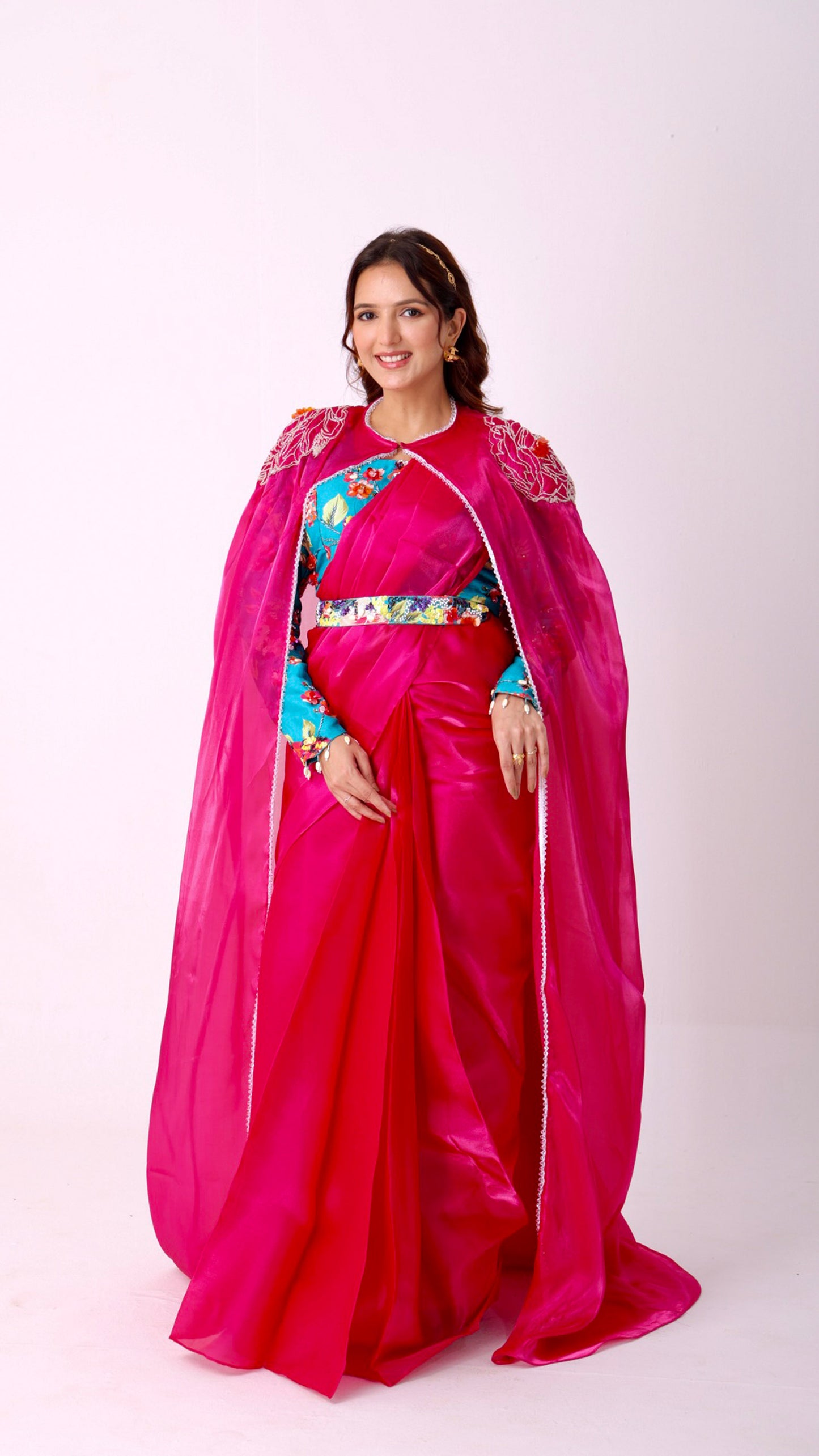 Fuchsia saree with embroidered cape & floral belt paired with printed blouse