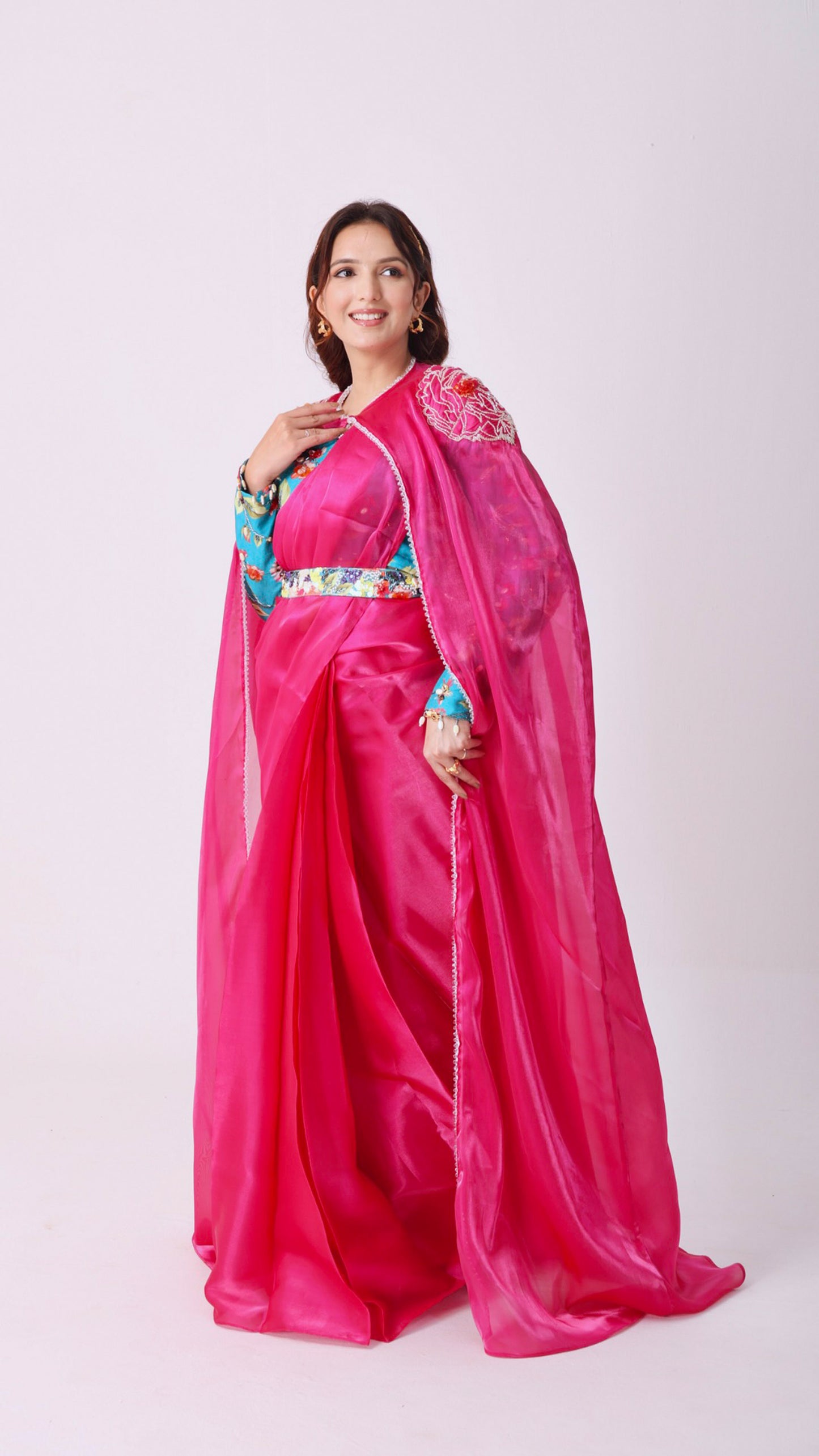 Fuchsia saree with embroidered cape & floral belt paired with printed blouse