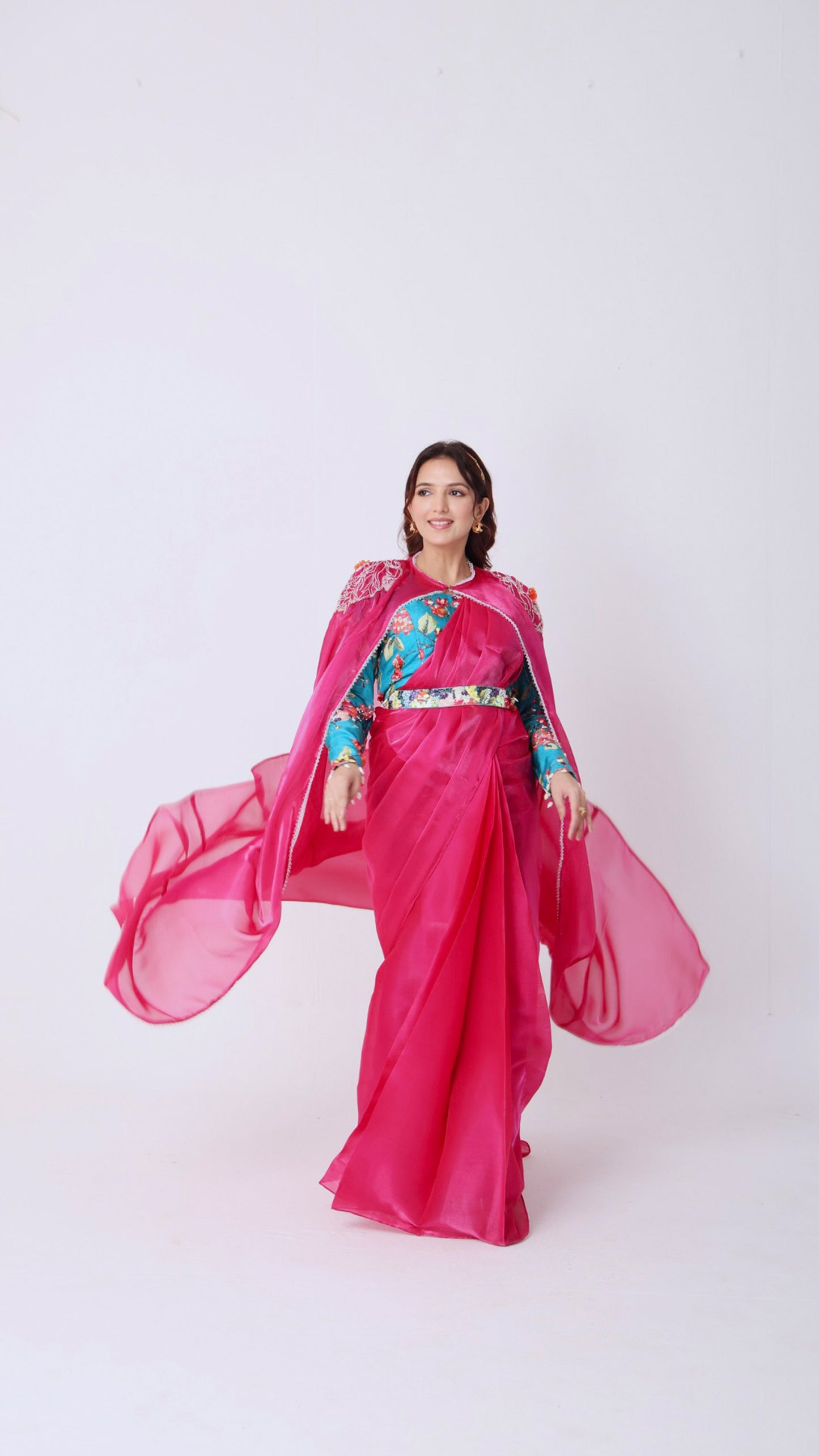 Fuchsia saree with embroidered cape & floral belt paired with printed blouse