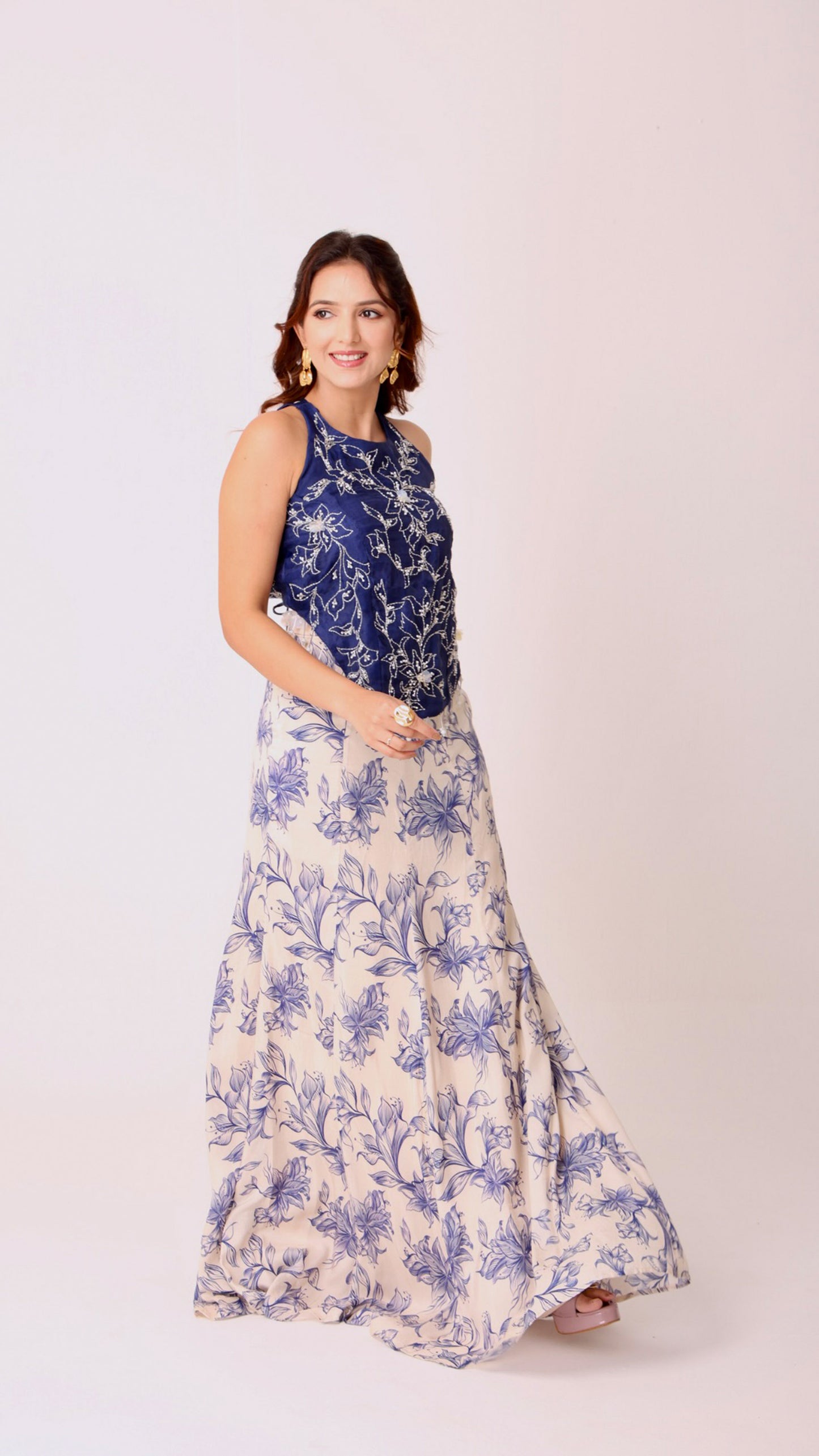 Navy hand-embroidered chic halter top paired with an ivory flared floral skirt
