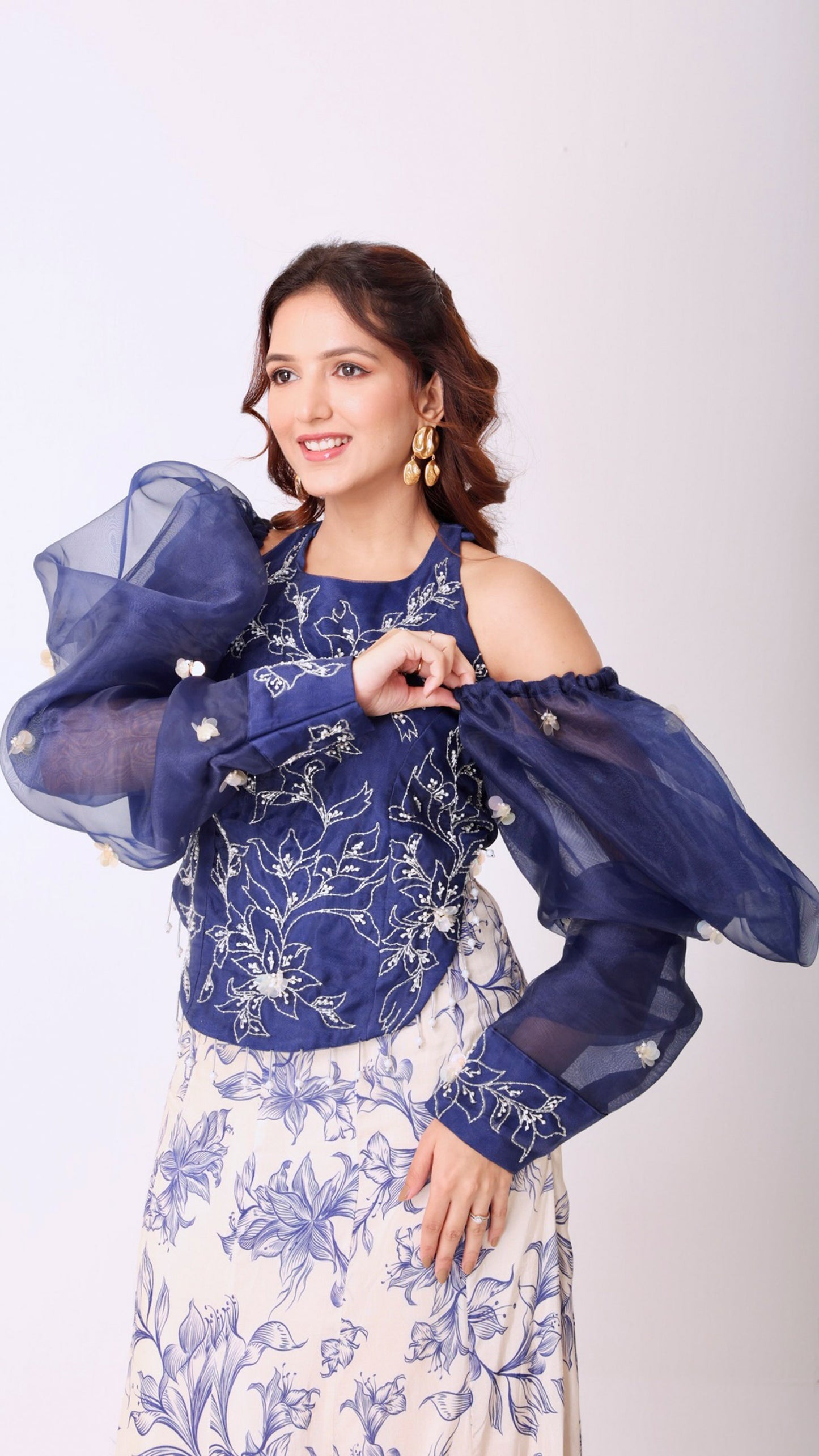 Embroidered navy halter top with dramatic puff sleeve & floral flair ivory skirt