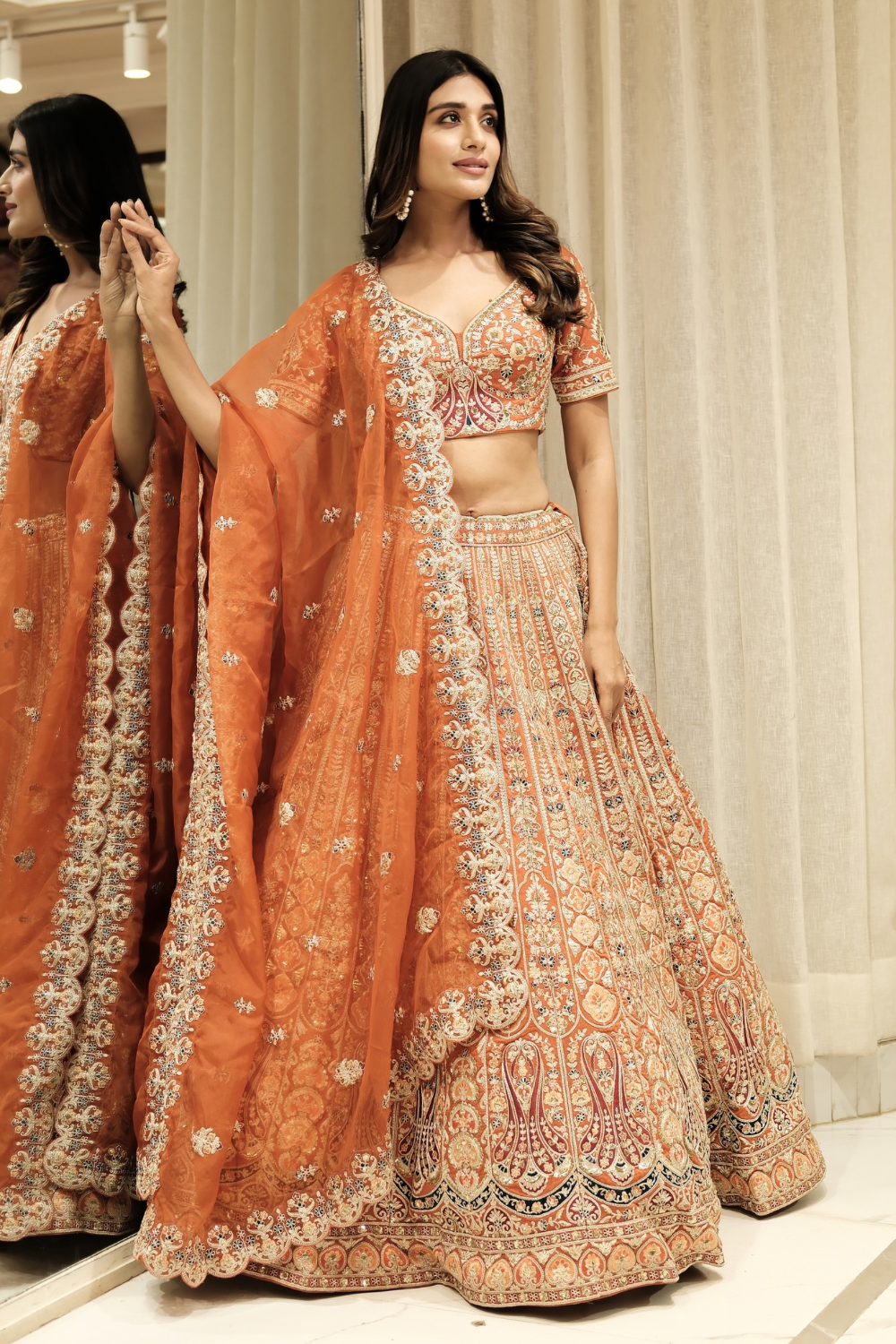Orange silk lehenga choli with aari and sequins work